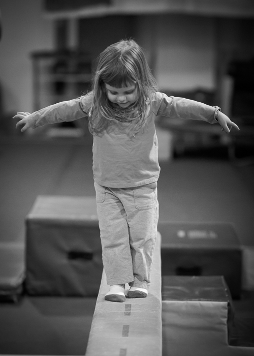 Lily on the practice balance beam at the Cary Gym