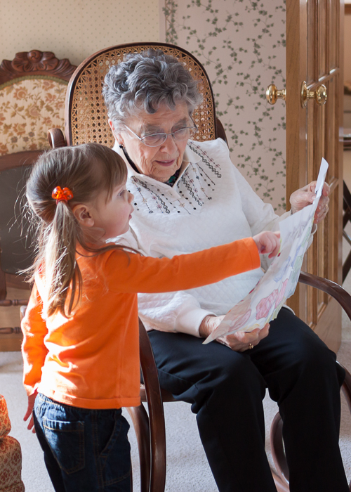 Lily explaining to Great Grandma Amling the artwork she created for her.